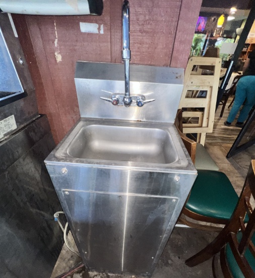 Stainless steel sink with towel and soap dispenser