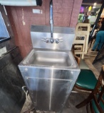Stainless steel sink with towel and soap dispenser