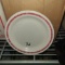 Round speckled plate with red rim