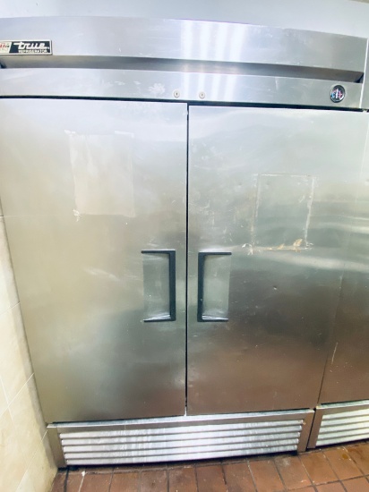 True T-49 stainless steel two door refrigerator mounted on casters complete with seven interior epox