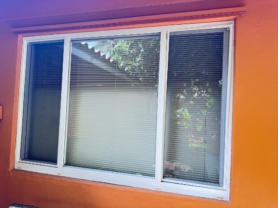 86 x 58 in.impact glass window with white frame and exterior screens slides open on both ends