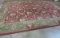 LARGE ORIENTAL  STYLE RUG, RED GROUND WITH GREEN BORDER (14' X 10')