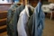 LOT OF VINTAGE MILITARY SHIRTS, PANTS, COVER ALLS AND COAT