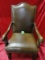 LEATHER AND WOOD ARM CHAIR WITH HIDE CROSS MOTIF ON THE BACK