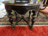 MARGE CARSON DISTRESSED BLACK AND GILT ROUND ACCENT TABLE,