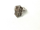 14KT WHITE GOLD AND DIAMOND RING: CONTAINING 34 CHOCOLATE DIAMONDS WITH WHITE DIAMONDS SET IN THE SH