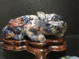 LAPIS LAZULI CARVED FOO LION ON MAHOGANY STAND, 12