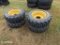 (4) 10-16.5 Skidsteer Tires on 8 hole rims