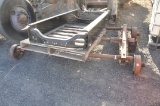 ROW OF 5 ASSORTED AXLES AND TRUCK FRAME PIECE