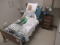 MEDICAL BED W/ TRAINING MANIKIN, ROLLING CABINET W/ PUMP & CONTENTS OF CABINET MOUNTED ON WALL