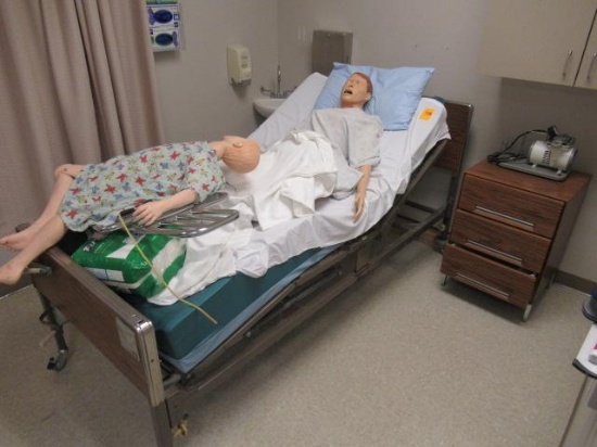 MEDICAL BED W/ (2) TRAINING MANIKINS, ROLLING CABINET W/ PUMP & CONTENTS OF CABINET MOUNTED ON WALL