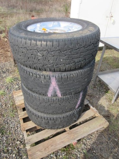 (4) LT215/70R18 TIRES ON 8 LUG ALUMINUM WHEELS