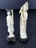 Male and Female carved statues on pedestals