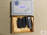 S&W box with grips, magazine, and cleaning tools