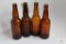 Four amber crown top beer bottles including OH, Ill, PA