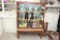 Hand carved wooden book shelf w/ 2 sliding glass doors 5’ x 3’8” x 1’5” contents not included