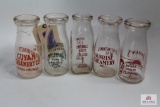 Five ½ pint WV decorated clear glass bottles