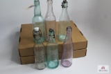 Six clear squat soda bottles including Mass, PA, NY, ME, DEL