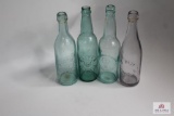 Four squat clear soda bottles including Mass, KY, & OH