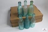 Seven Semi squat blue soda bottles including NY, GA, MO, Conn