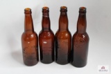 Four amber crown top beer bottles including KY, OH, MD