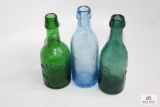 Three semi squat bottles 2 green glass, E Roussel Philadelphia PA/Ledlie Trenton NJ, 1 Blue C