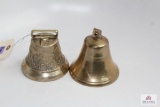 Two medium brass colored bells, one eagle pattern