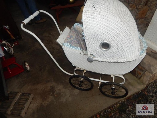 Early baby buggy with sunshield and rubber wheels
