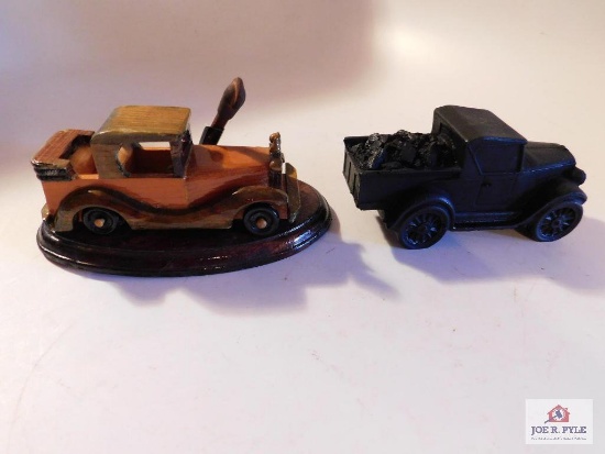 Old truck made out of coal and car made out of wood and a pencil