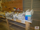Contents on work bench to include: wood bleaching solution, sand paper, finishing film discs, etc.
