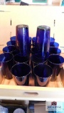 Blue water glasses in wood tray