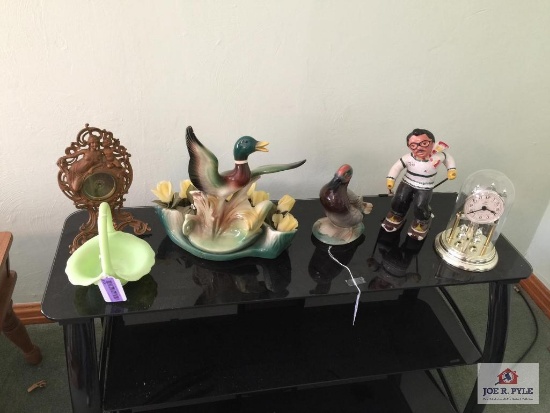 Lot top of TV stand: Cast clock, ducks, Fenton basket, pottery skier, etc.