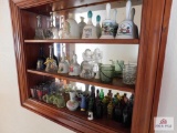 Contents of shelf bells, shot glasses, miniature bottles