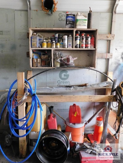Contents of shelf and below, gas cans, cooler, tubing, paint supplies