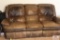 Brown leather couch that reclines on both ends