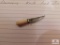 Handmade miniature knife hat pin by Marvin Wotring - Damascus blade, antler handle