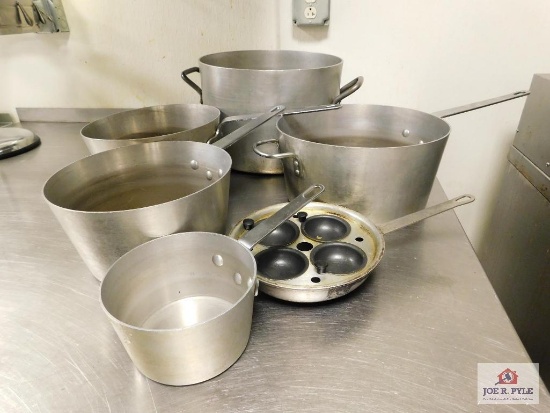 Assorted stainless steel pots with crestware, egg poacher skillet