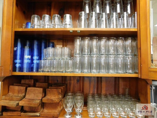 Contents of cabinet, assorted glassware, Pepsi cups, napkin holders