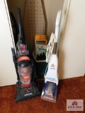 Contents of closet - vacuums, sweeper bags, ironing board