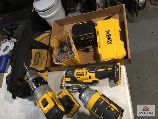 Lot: DEWALT portable saw, drills, battery, charger, and bag