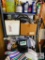 shelf and its contents: garden hose, cleaning towels, rakes, etc..