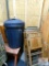 metal folding table, wooden folding chairs, bench, vintage iron board, and trash can with lid