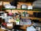contents of shelves: rugs, crock pot, canning pot, food scale, cutting boards, large baking sheets