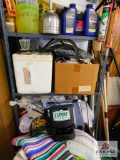 shelf and its contents: garden hose, cleaning towels, rakes, etc..