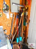 group of brooms, walking sticks, canes, small flag holders, and spotlight