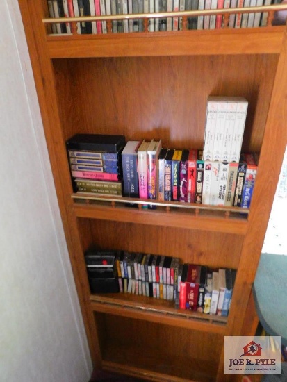2 shelves of books and movies