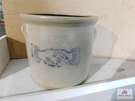 Shaking hands stoneware crock