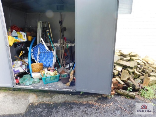 Contents of storage unit: chairs planters, gas cans and flat stones