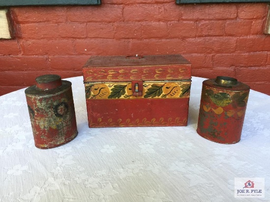 Three pieces of red tole-ware, two lidded