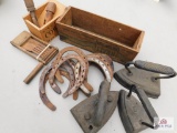 Sad irons, noise maker, horse shoes and wood box